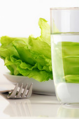 fresh iceberg salad with a glass of water