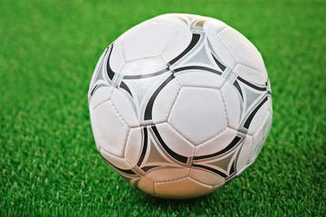 Fototapeta premium Soccer ball against grass background