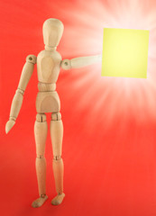 wooden figure holding empty adhesive note