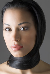 Naklejka premium beautiful latina girl in a close up with hair around her neck