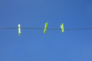 clothes line with green clothespin (blue sky)