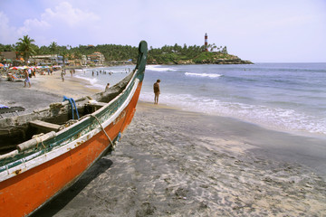 boat at crowded beach, kerala, india