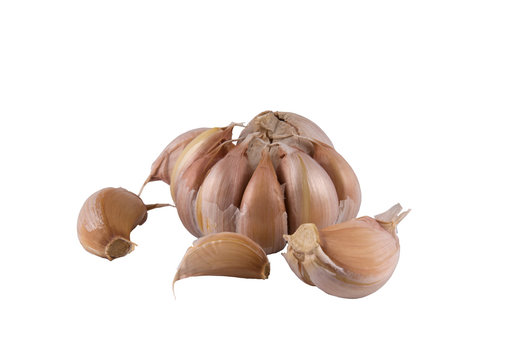 Some segments of garlic and the whole head on a light background
