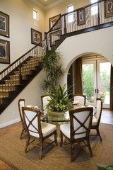 Dining room with luxury home stairway.