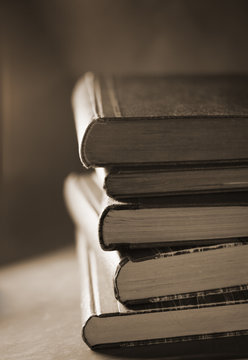Sepia toned photo of a stack of old books
