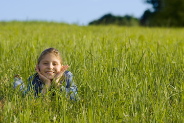 The girl lays on a grass