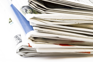 Stack of newspapers on white background