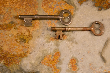 Old skeleton type keys on a solid slate stone foundation
