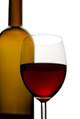 Bottle and glass of red wine isolated over white background