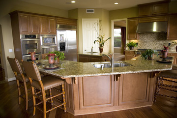 Luxury home kitchen with a granite top island. 