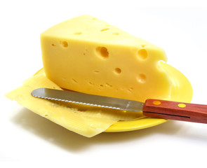 Piece of cheese on the plate with knife isolated over white