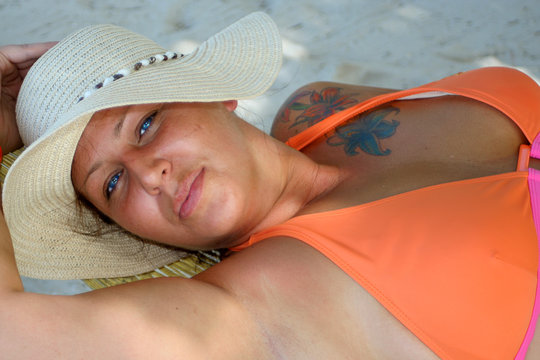 blue eyed woman relaxing on a tropical beach
