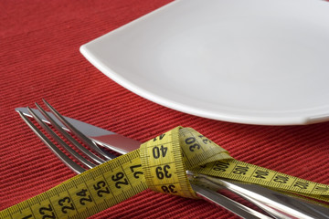 Fork and knife tieup with a measure tape. 
