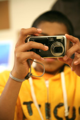 Young man taking pictures with a digital camera