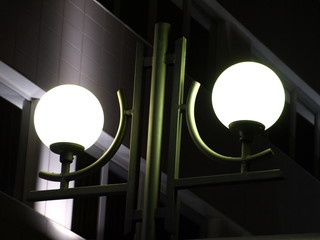 Lamppost with energy saving lamps of street illumination at night