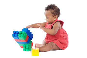 Adorable baby girl playing with building blocks