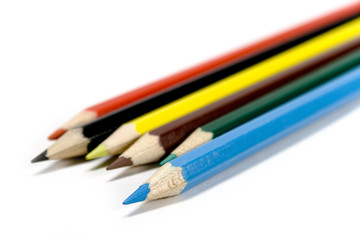 Six coloured pencils over white background