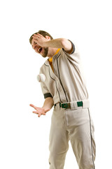 A young male baseball player hit by a ball