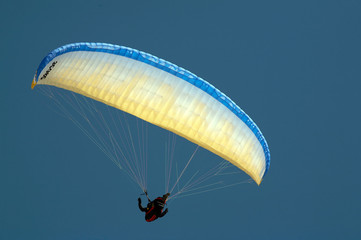 colorful paraglider against the blue sky