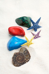 colorful stones and starfishes in the white sand
