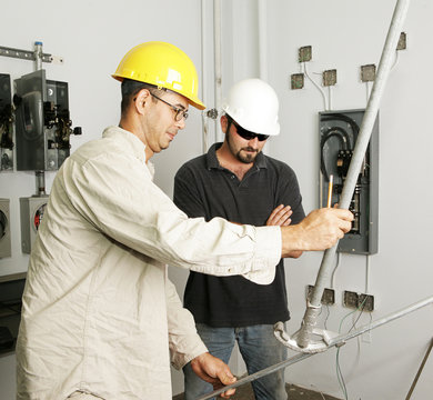 Electrician and foreman bending pipe for a job. 