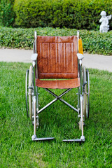 Fototapeta na wymiar Wheelchair outside on grass