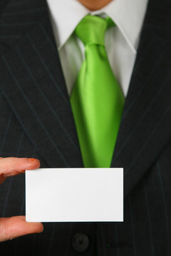 Blank Business Card In Color White In Front Of Suit And Tie