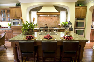 Luxury home kitchen with a granite island.