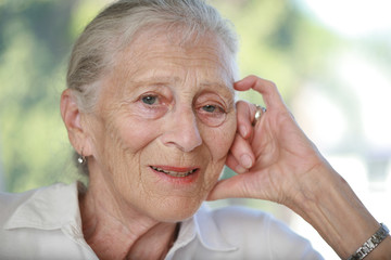Close-up portrait of senior woman contemplating. Shallow DOF.