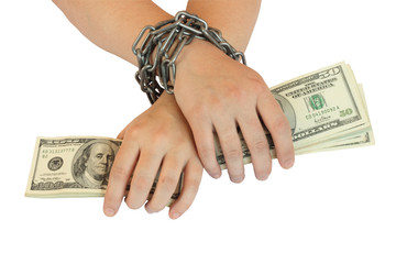 hands with dollar are bound by chain