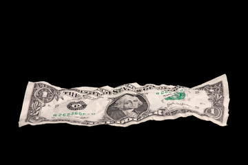 one crumpled dollar isolated on black