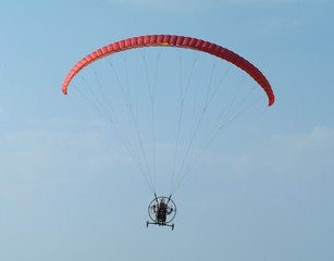 Paramotor with wheels, a motorized paraglider, flying.