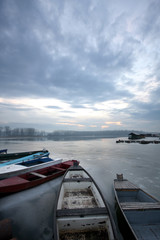 old boat on frozen river Danube in january