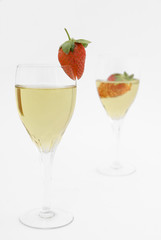 Two champagne glasses with fresh and ripe strawberries