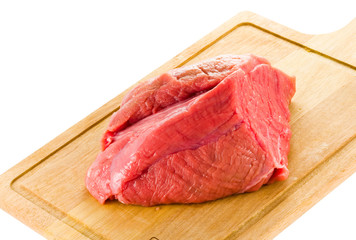 raw beef on wood board isolated on white background