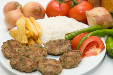 meat balls with french fries and rice on white