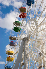 Colorful Ferris wheel over blue sky