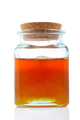 Jar of honey isolated on white background