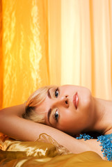 Naklejka na ściany i meble Young woman lying in bed