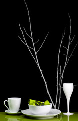 A modern interior shot of a dinner table set for one