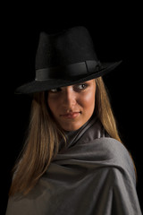 young woman in black hat on black