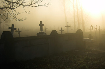 Old gloomy cemetery in a morning fog