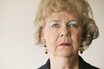 Close-up of a senior woman looking directly at the camera.