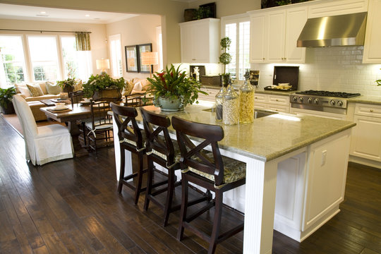 Modern kitchen with hardwood floor and island.