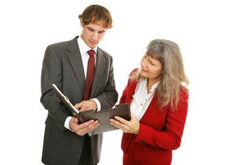 Young male employee showing his female boss the report.  