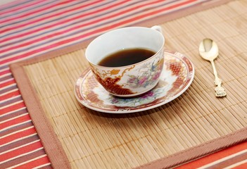 Cup of coffee and gold spoon