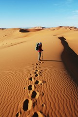Man go up in sand desert