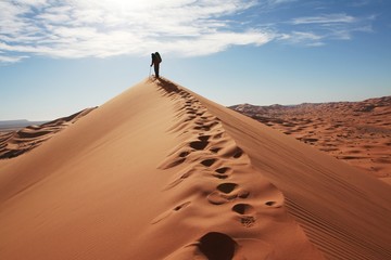 Man go up in sand desert