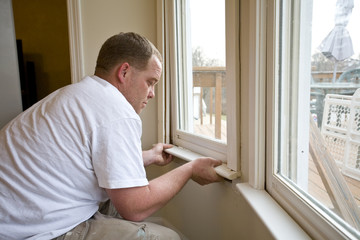 Carpenter repairing window frames