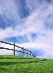 An ranch-style wooden fence with a sky background. - 5848859